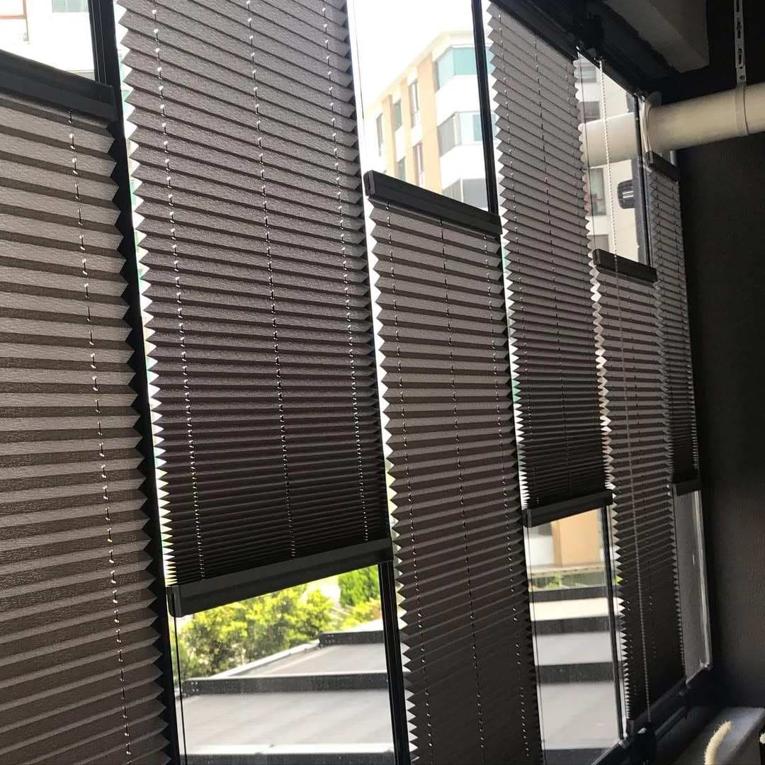Balcony with cellular blinds covering the windows, a chair, and a small table