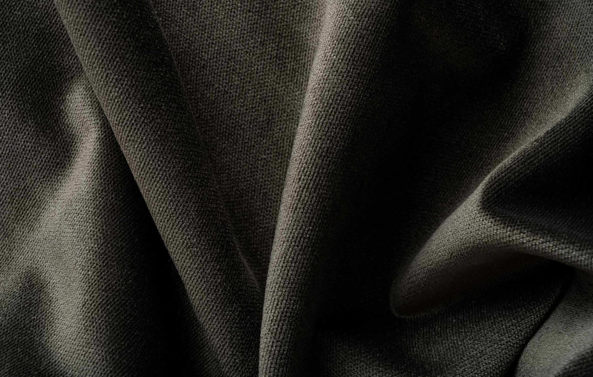 Close-up of dark, textured, and folded fabric.